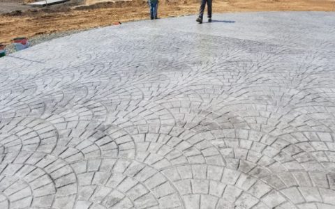 A large concrete area patterned with European fan cobblestone
